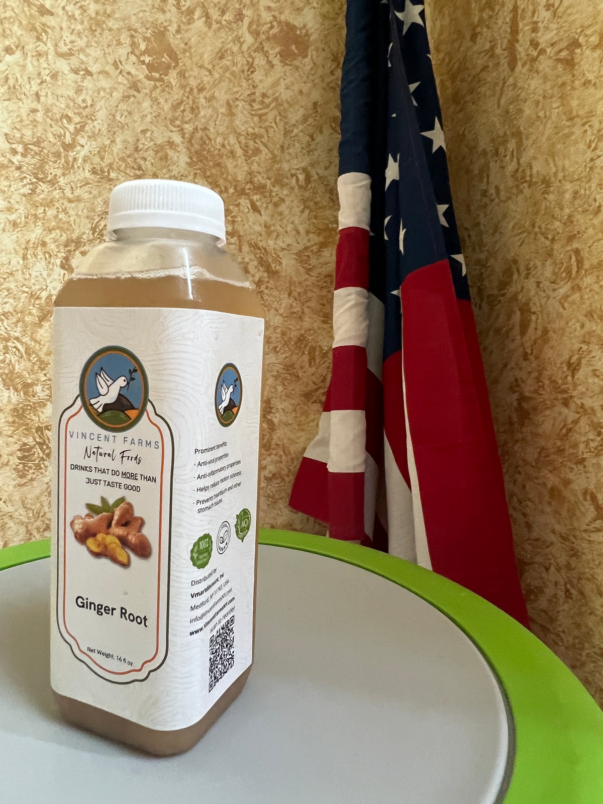 Close-up of Vincent Farms Ginger Cold Herbal Drink bottle showing label detail — naturally grown, caffeine-free