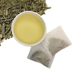 Freshly brewed Moringa & Lemongrass herbal tea in a glass cup — light golden color, caffeine-free wellness blend. Combines the rich nutrients of Moringa oleifera leaves with the soothing, citrus-like properties of lemongrass